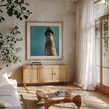 Atlantic Lighthouse by Sue Schlabach. Shown in a natural wood frame in a cozy modern living room. Available as an archival giclee rolled canvas, fine art paper, or poster print. SKU 25828a.