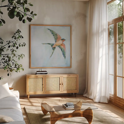 Barn Swallow Flight II by Sue Schlabach. Shown in a natural wood frame in a cozy modern living room. Available as an archival giclee rolled canvas, fine art paper, or poster print. SKU 84228a.