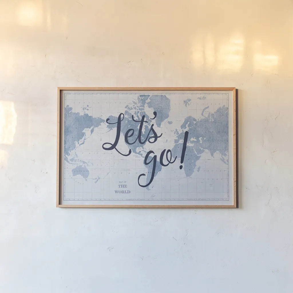 Blueprint World Map Lets Go by Sue Schlabach. shown as a paper print in a natural frame. Available as a archival giclee rolled canvas, fine art paper, or poster print. SKU 75013i.