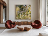 Blush Blossoms I Square by Sue Schlabach. Shown as extra-large giant wall art in a modern living room. Available as an archival giclee rolled canvas, fine art paper, or poster print. SKU 22115a.