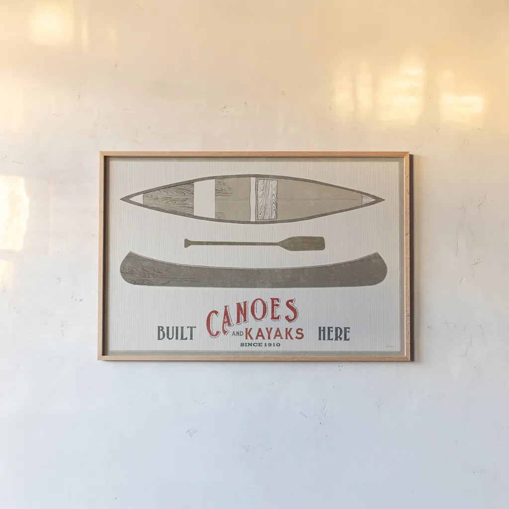 Cabin Life VII Kayak by Sue Schlabach. shown as a paper print in a natural frame. Available as a archival giclee rolled canvas, fine art paper, or poster print. SKU 53655i.