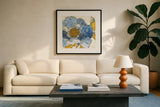 Camilles Peony I Indigo by Sue Schlabach. Displayed in a glass frame with matte in a clean modern living room. Available as an archival giclee rolled canvas, fine art paper, or poster print. SKU 23970a.