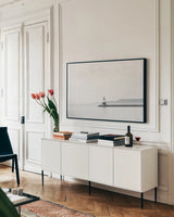 Casco Bay Lighthouse II by Sue Schlabach. shown as a framed stretched canvas in a living room above a console. Available as a archival giclee rolled canvas, fine art paper, or poster print. SKU 72425i.