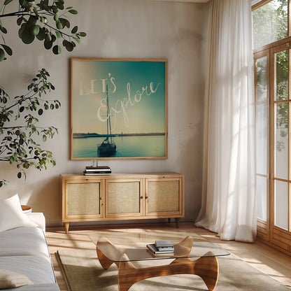 Coastline Sailboat Explore by Sue Schlabach. Shown in a natural wood frame in a cozy modern living room. Available as an archival giclee rolled canvas, fine art paper, or poster print. SKU 15251a.