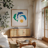 Dolphin Dance by Sue Schlabach. Shown in a natural wood frame in a cozy modern living room. Available as an archival giclee rolled canvas, fine art paper, or poster print. SKU 65509a.