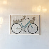 Doxie Ride ver II by Sue Schlabach. shown as a paper print in a white frame. Available as a archival giclee rolled canvas, fine art paper, or poster print. SKU 22131i.
