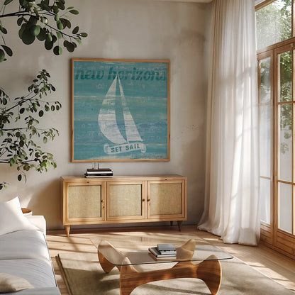 Drift Sailboat by Sue Schlabach. Shown in a natural wood frame in a cozy modern living room. Available as an archival giclee rolled canvas, fine art paper, or poster print. SKU 18845a.