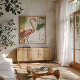 Flamingo Curiosity I by Sue Schlabach. Shown in a natural wood frame in a cozy modern living room. Available as an archival giclee rolled canvas, fine art paper, or poster print. SKU 13427a.