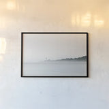 Foggy Lighthouse by Sue Schlabach. shown as a paper print in a black flame. Available as a archival giclee rolled canvas, fine art paper, or poster print. SKU 72426i.