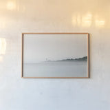 Foggy Lighthouse by Sue Schlabach. shown as a paper print in a natural frame. Available as a archival giclee rolled canvas, fine art paper, or poster print. SKU 72426i.