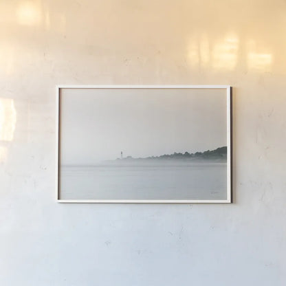 Foggy Lighthouse by Sue Schlabach. shown as a paper print in a white frame. Available as a archival giclee rolled canvas, fine art paper, or poster print. SKU 72426i.