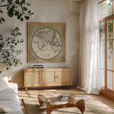 French World Map II by Sue Schlabach. Shown in a natural wood frame in a cozy modern living room. Available as an archival giclee rolled canvas, fine art paper, or poster print. SKU 13226a.