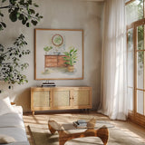 Greenery Bath I by Sue Schlabach. Shown in a natural wood frame in a cozy modern living room. Available as an archival giclee rolled canvas, fine art paper, or poster print. SKU 57649a.