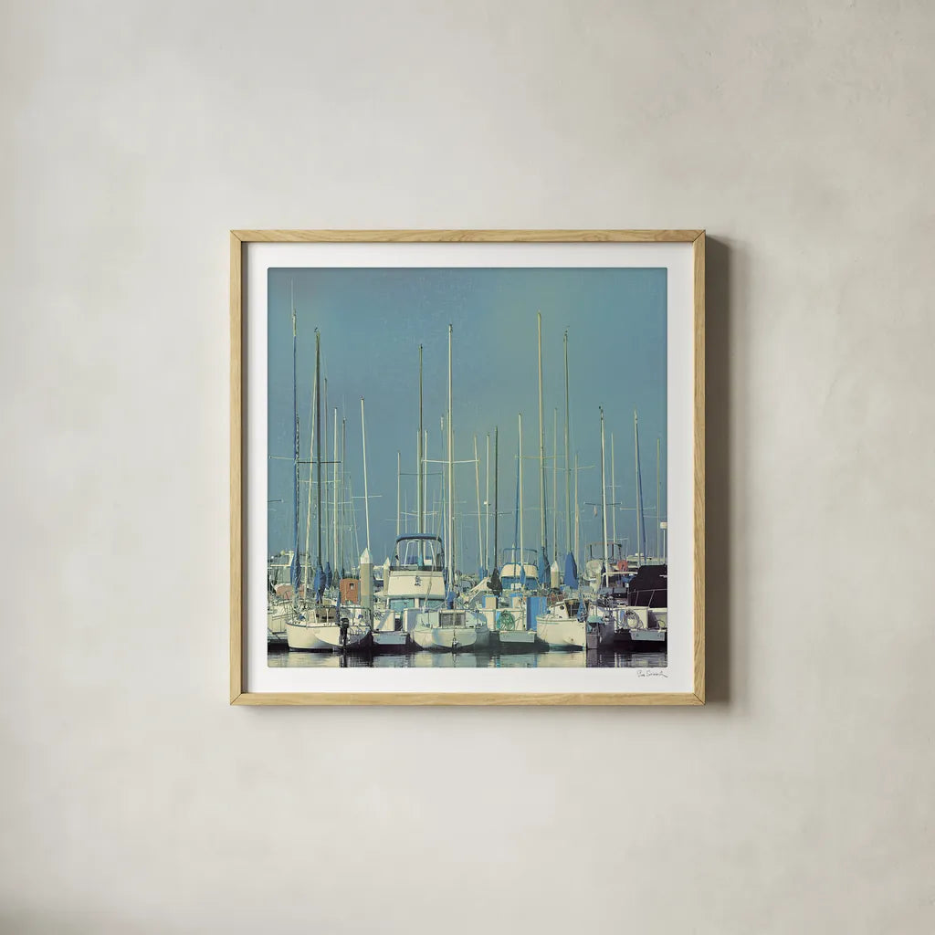 Harbor Boats Blue Sky by Sue Schlabach. Shown in a natural wood glass frame for a timeless modern aesthetic. Available as an archival giclee rolled canvas, fine art paper, or poster print. SKU 23865a.