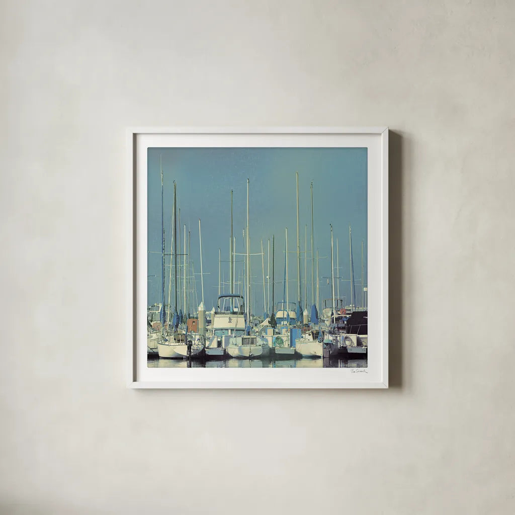 Harbor Boats Blue Sky by Sue Schlabach. Shown in a crisp white glass frame for a clean and minimalist style. Available as an archival giclee rolled canvas, fine art paper, or poster print. SKU 23865a.