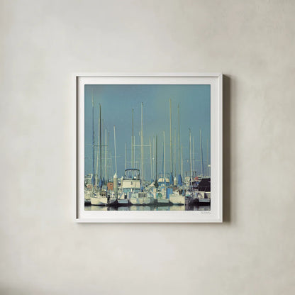 Harbor Boats Blue Sky by Sue Schlabach. Shown in a crisp white glass frame for a clean and minimalist style. Available as an archival giclee rolled canvas, fine art paper, or poster print. SKU 23865a.