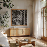 Kuba Cloth Mat III Crop BW by Sue Schlabach. Shown in a natural wood frame in a cozy modern living room. Available as an archival giclee rolled canvas, fine art paper, or poster print. SKU 32131a.