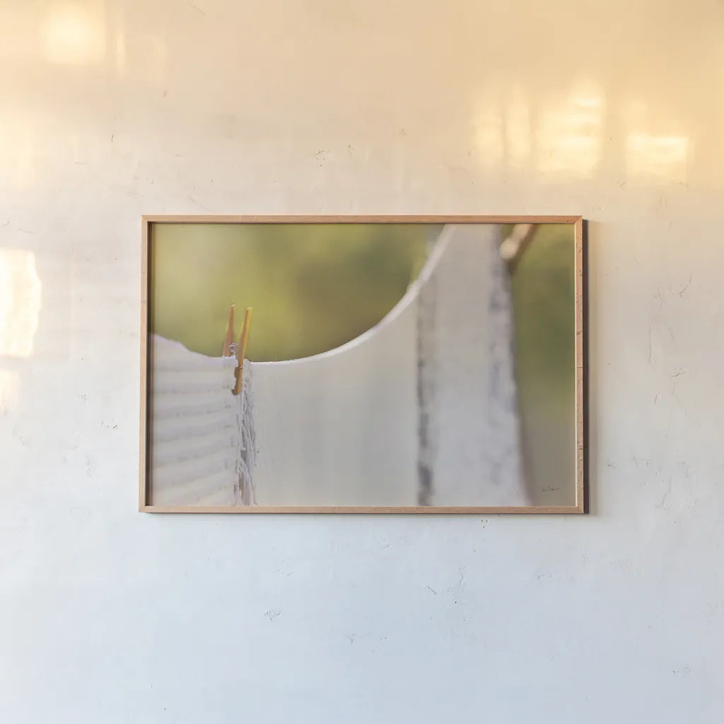 Laundry Day by Sue Schlabach. shown as a paper print in a natural frame. Available as a archival giclee rolled canvas, fine art paper, or poster print. SKU 34129i.