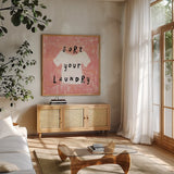 Laundry Rules III by Sue Schlabach. Shown in a natural wood frame in a cozy modern living room. Available as an archival giclee rolled canvas, fine art paper, or poster print. SKU 35899a.