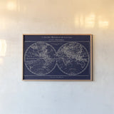 Map of the World Indigo by Sue Schlabach. shown as a paper print in a natural frame. Available as a archival giclee rolled canvas, fine art paper, or poster print. SKU 14706i.