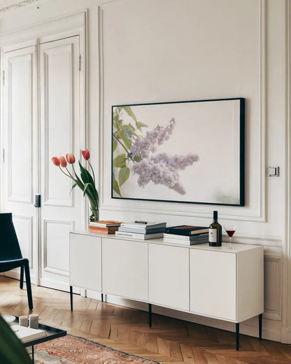 Pale Lilacs I by Sue Schlabach. shown as a framed stretched canvas in a living room above a console. Available as a archival giclee rolled canvas, fine art paper, or poster print. SKU 72129i.