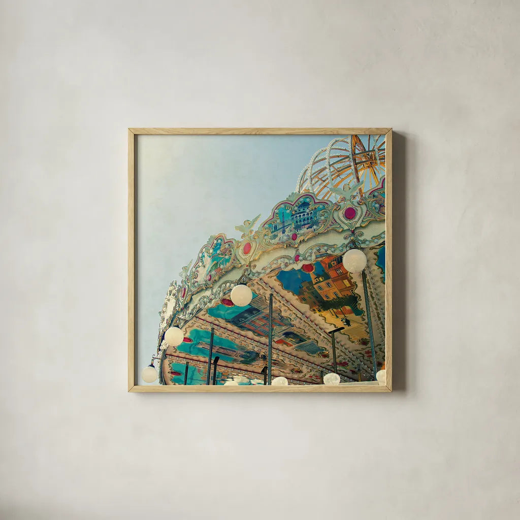 Paris Carousel II Aged by Sue Schlabach. Shown in a natural wood glass frame for a timeless modern aesthetic. Available as an archival giclee rolled canvas, fine art paper, or poster print. SKU 34161a.