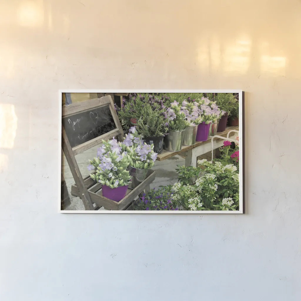 Paris Flower Market by Sue Schlabach. shown as a paper print in a white frame. Available as a archival giclee rolled canvas, fine art paper, or poster print. SKU 34133i.
