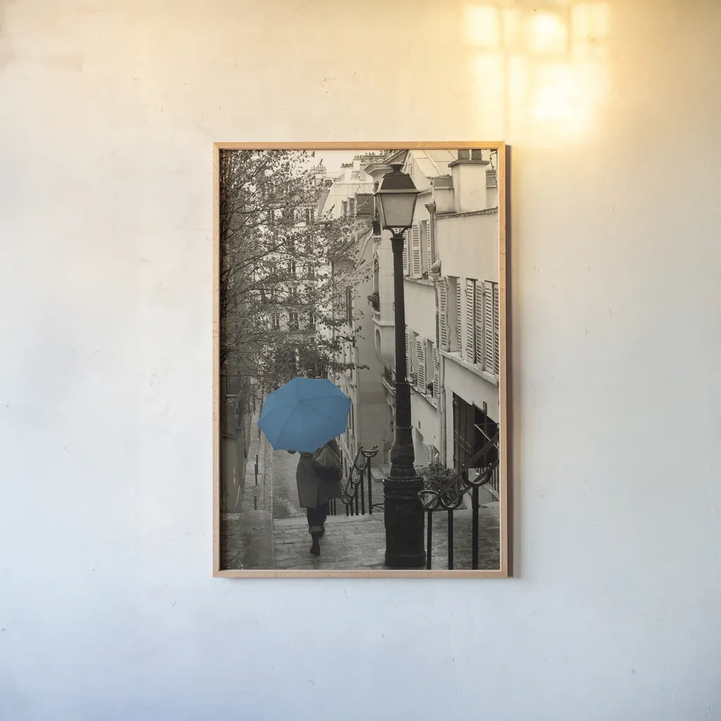 Paris Stroll II Teal Umbrella by Sue Schlabach. shown as a paper print in a natural frame. Available as a archival giclee rolled canvas, fine art paper, or poster print. SKU 44745h.