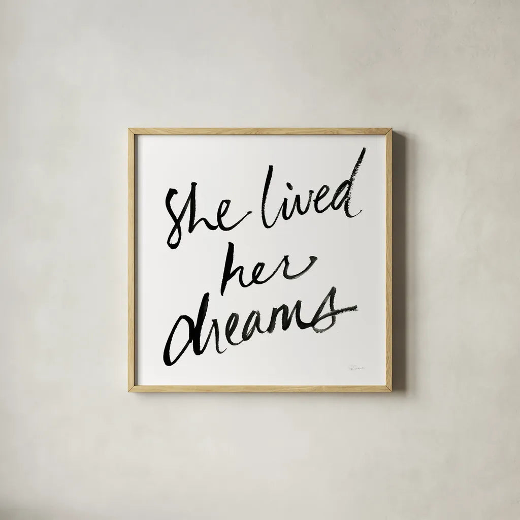 She Lived Her Dreams by Sue Schlabach. Shown in a natural wood glass frame for a timeless modern aesthetic. Available as an archival giclee rolled canvas, fine art paper, or poster print. SKU 48128a.
