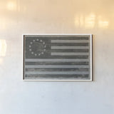 Slate American Flag by Sue Schlabach. shown as a paper print in a white frame. Available as a archival giclee rolled canvas, fine art paper, or poster print. SKU 67594i.