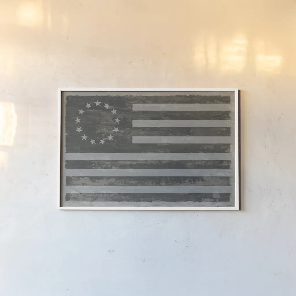 Slate American Flag by Sue Schlabach. shown as a paper print in a white frame. Available as a archival giclee rolled canvas, fine art paper, or poster print. SKU 67594i.