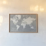 Slate World Map by Sue Schlabach. shown as a paper print in a natural frame. Available as a archival giclee rolled canvas, fine art paper, or poster print. SKU 51520i.