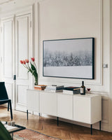 Snowshoe Hill by Sue Schlabach. shown as a framed stretched canvas in a living room above a console. Available as a archival giclee rolled canvas, fine art paper, or poster print. SKU 60937i.
