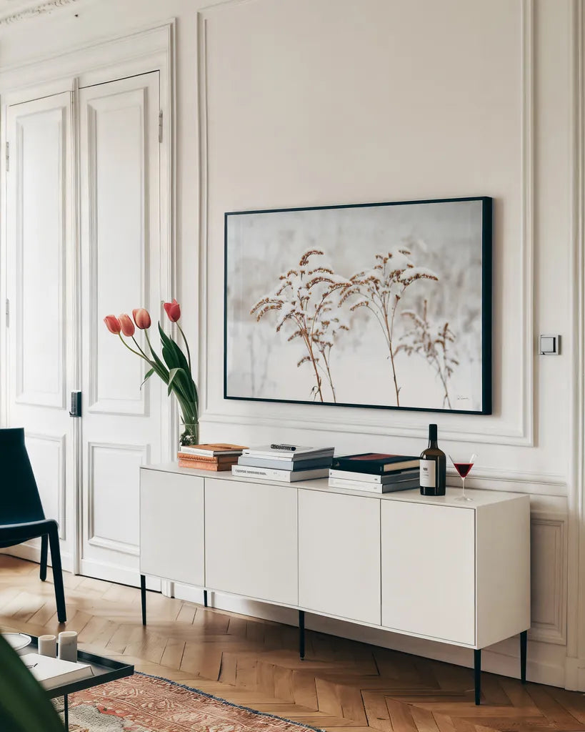 Snowy Gardens by Sue Schlabach. shown as a framed stretched canvas in a living room above a console. Available as a archival giclee rolled canvas, fine art paper, or poster print. SKU 75783i.