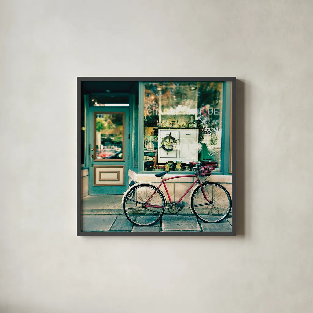 Sunday Morning Bike by Sue Schlabach. Shown in a sleek black glass frame for a contemporary gallery look. Available as an archival giclee rolled canvas, fine art paper, or poster print. SKU 15412a.