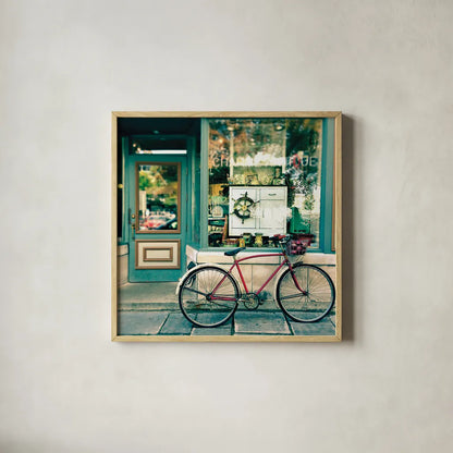 Sunday Morning Bike by Sue Schlabach. Shown in a natural wood glass frame for a timeless modern aesthetic. Available as an archival giclee rolled canvas, fine art paper, or poster print. SKU 15412a.