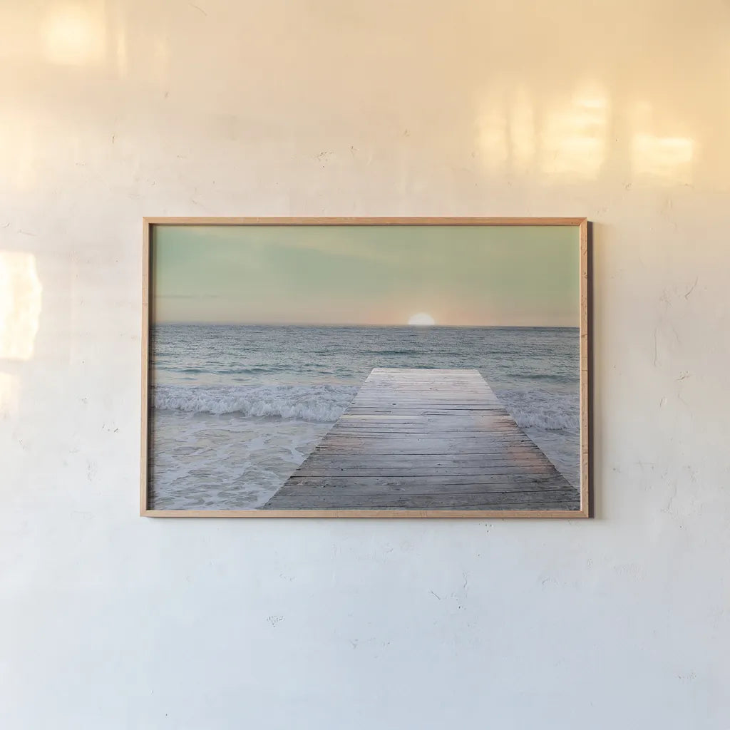 Sunrise Dock by Sue Schlabach. shown as a paper print in a natural frame. Available as a archival giclee rolled canvas, fine art paper, or poster print. SKU 18852i.