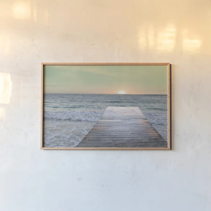 Sunrise Dock by Sue Schlabach. shown as a paper print in a natural frame. Available as a archival giclee rolled canvas, fine art paper, or poster print. SKU 18852i.