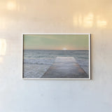 Sunrise Dock by Sue Schlabach. shown as a paper print in a white frame. Available as a archival giclee rolled canvas, fine art paper, or poster print. SKU 18852i.