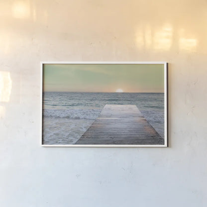 Sunrise Dock by Sue Schlabach. shown as a paper print in a white frame. Available as a archival giclee rolled canvas, fine art paper, or poster print. SKU 18852i.