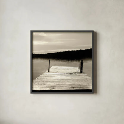 Twilight Dock III Sepia by Sue Schlabach. Shown in a sleek black glass frame for a contemporary gallery look. Available as an archival giclee rolled canvas, fine art paper, or poster print. SKU 11292a.