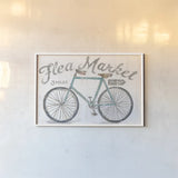 White Barn Flea Market I by Sue Schlabach. shown as a paper print in a white frame. Available as a archival giclee rolled canvas, fine art paper, or poster print. SKU 31765i.