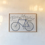 White Barn Flea Market I Blue Gray by Sue Schlabach. shown as a paper print in a natural frame. Available as a archival giclee rolled canvas, fine art paper, or poster print. SKU 56465i.