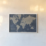 World Map Collage Deep by Sue Schlabach. shown as a paper print in a white frame. Available as a archival giclee rolled canvas, fine art paper, or poster print. SKU 75338i.