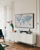 World Map Collage Explore by Sue Schlabach. shown as a framed stretched canvas in a living room above a console. Available as a archival giclee rolled canvas, fine art paper, or poster print. SKU 75340i.