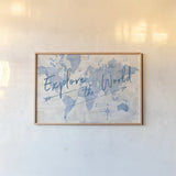 World Map Collage Explore by Sue Schlabach. shown as a paper print in a natural frame. Available as a archival giclee rolled canvas, fine art paper, or poster print. SKU 75340i.