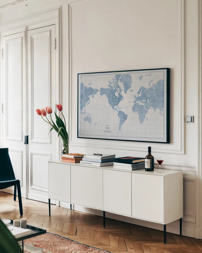 World Map White and Blue by Sue Schlabach. shown as a framed stretched canvas in a living room above a console. Available as a archival giclee rolled canvas, fine art paper, or poster print. SKU 48172i.