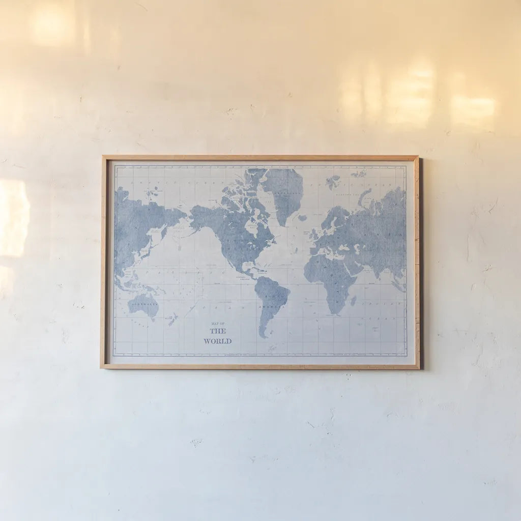 World Map White and Blue by Sue Schlabach. shown as a paper print in a natural frame. Available as a archival giclee rolled canvas, fine art paper, or poster print. SKU 48172i.