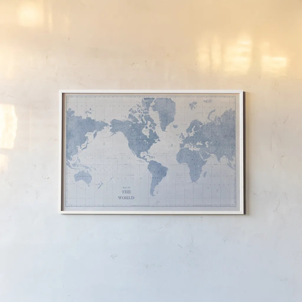 World Map White and Blue by Sue Schlabach. shown as a paper print in a white frame. Available as a archival giclee rolled canvas, fine art paper, or poster print. SKU 48172i.