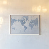 World Map White and Blue by Sue Schlabach. shown as a paper print in a white frame. Available as a archival giclee rolled canvas, fine art paper, or poster print. SKU 48172i.